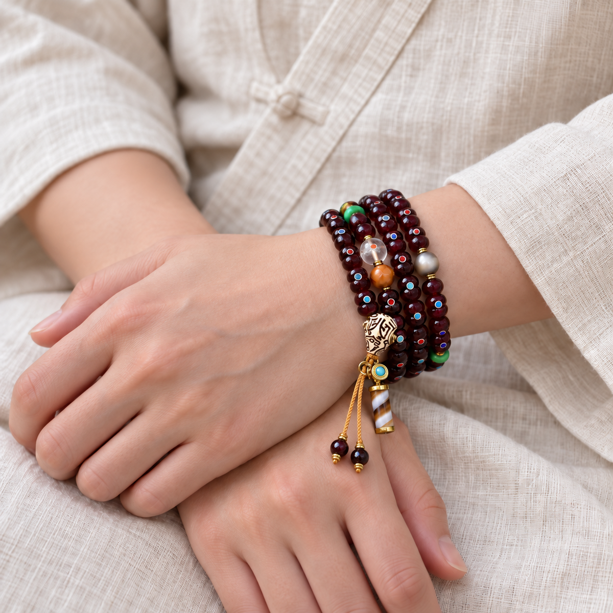 EverestArtstudios Natural Cinnabar-Finished Inlaid Xingyue Bodhi 108-Bead Mala — wrist crossed