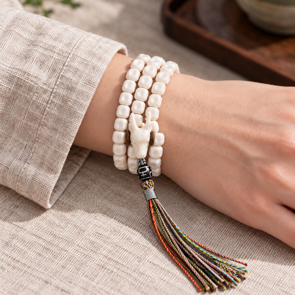 EverestArtstudios Natural Antler and Passion Seed 108-Bead Tibetan Mala Necklace — wrist resting
