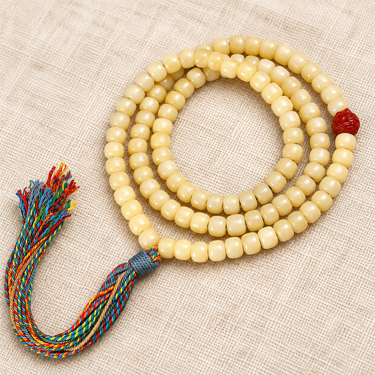 Golden white camel bone Tibetan mala — accent detail