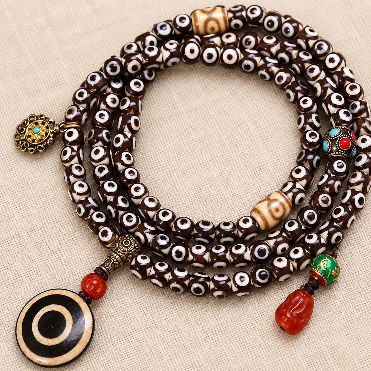 EverestArtstudios Natural Three-Eye Dzi and Red Agate 108-Bead Tibetan Mala — accent detail