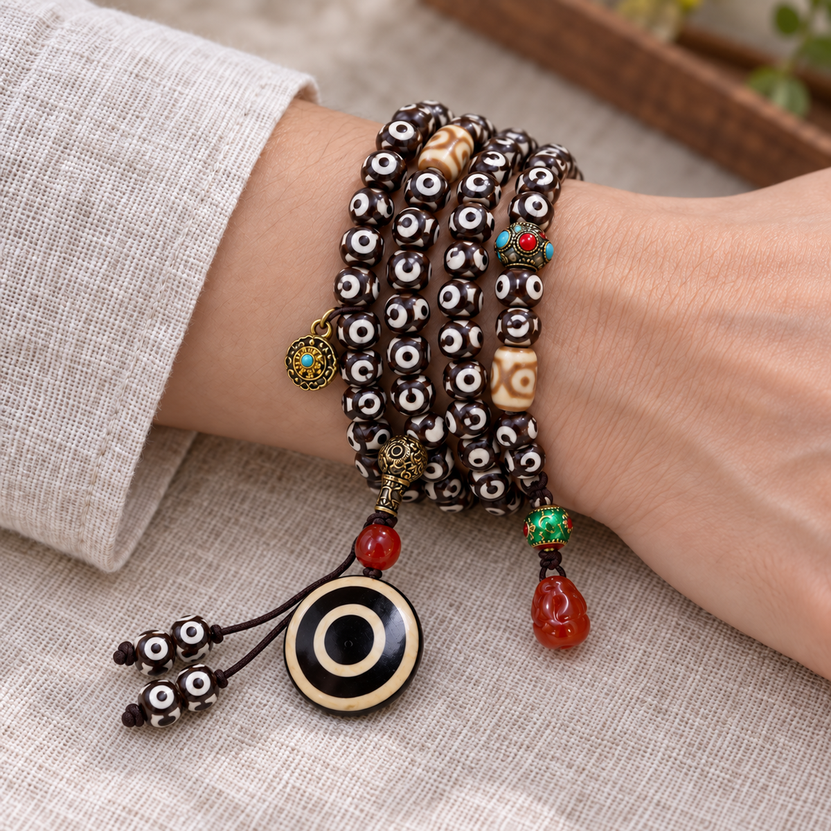 EverestArtstudios Natural Three-Eye Dzi and Red Agate 108-Bead Tibetan Mala — wrist resting