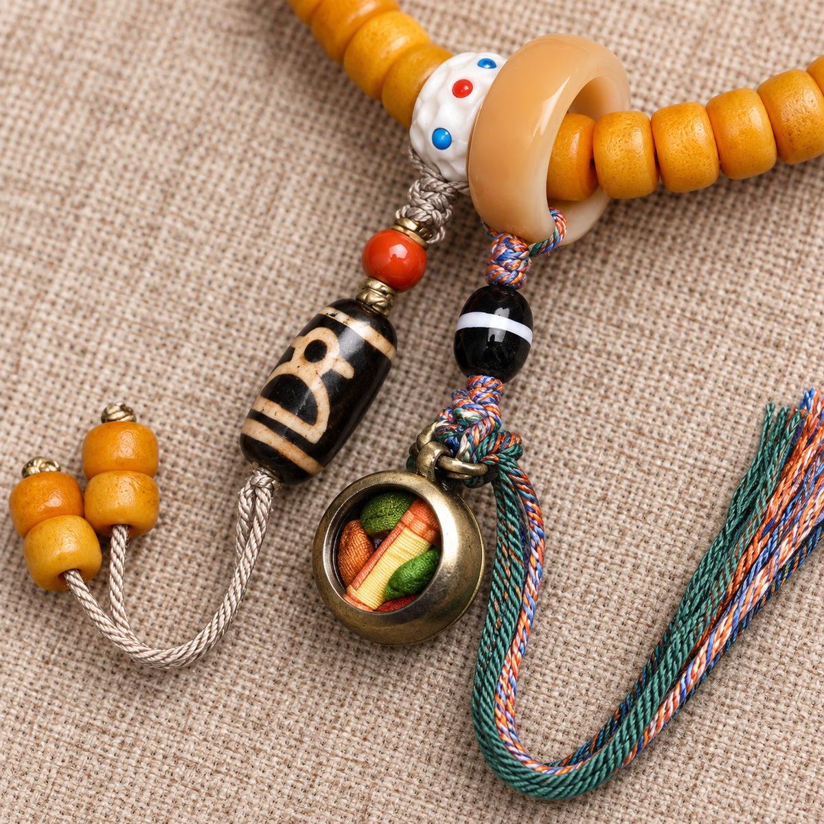 Golden-yellow camel bone 108-bead mala — charm detail