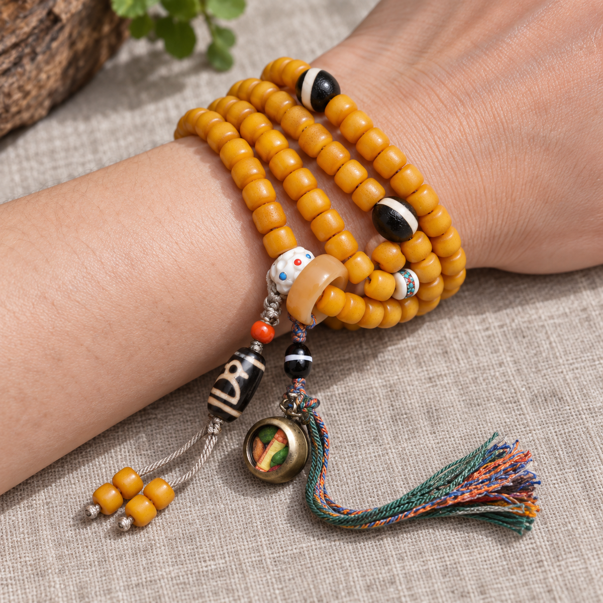 Golden-yellow camel bone 108-bead mala — wrist resting