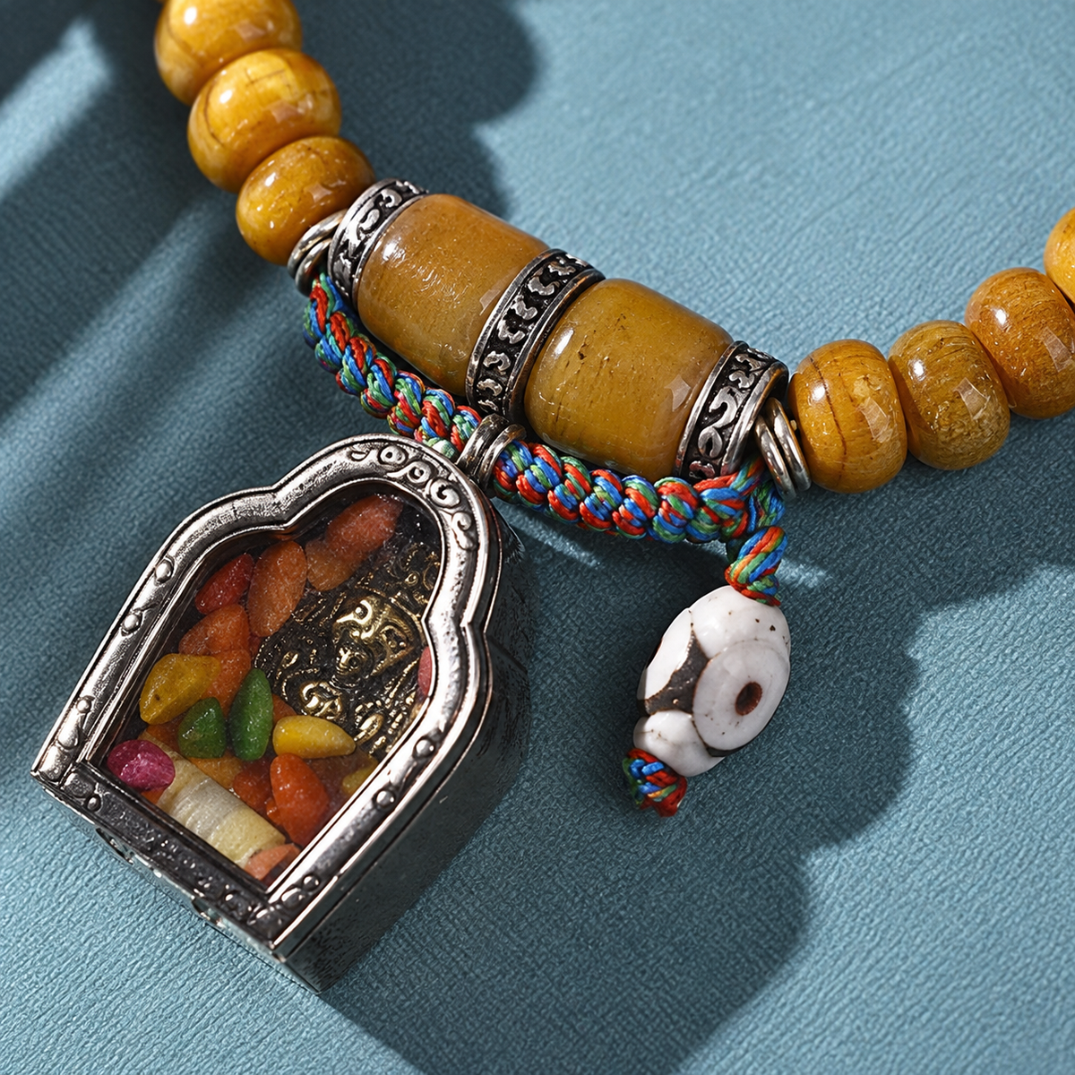 EverestArtstudios Natural Camel Bone 108-Bead Mala with Zaki Lhamo Gau Pendant — connection detail
