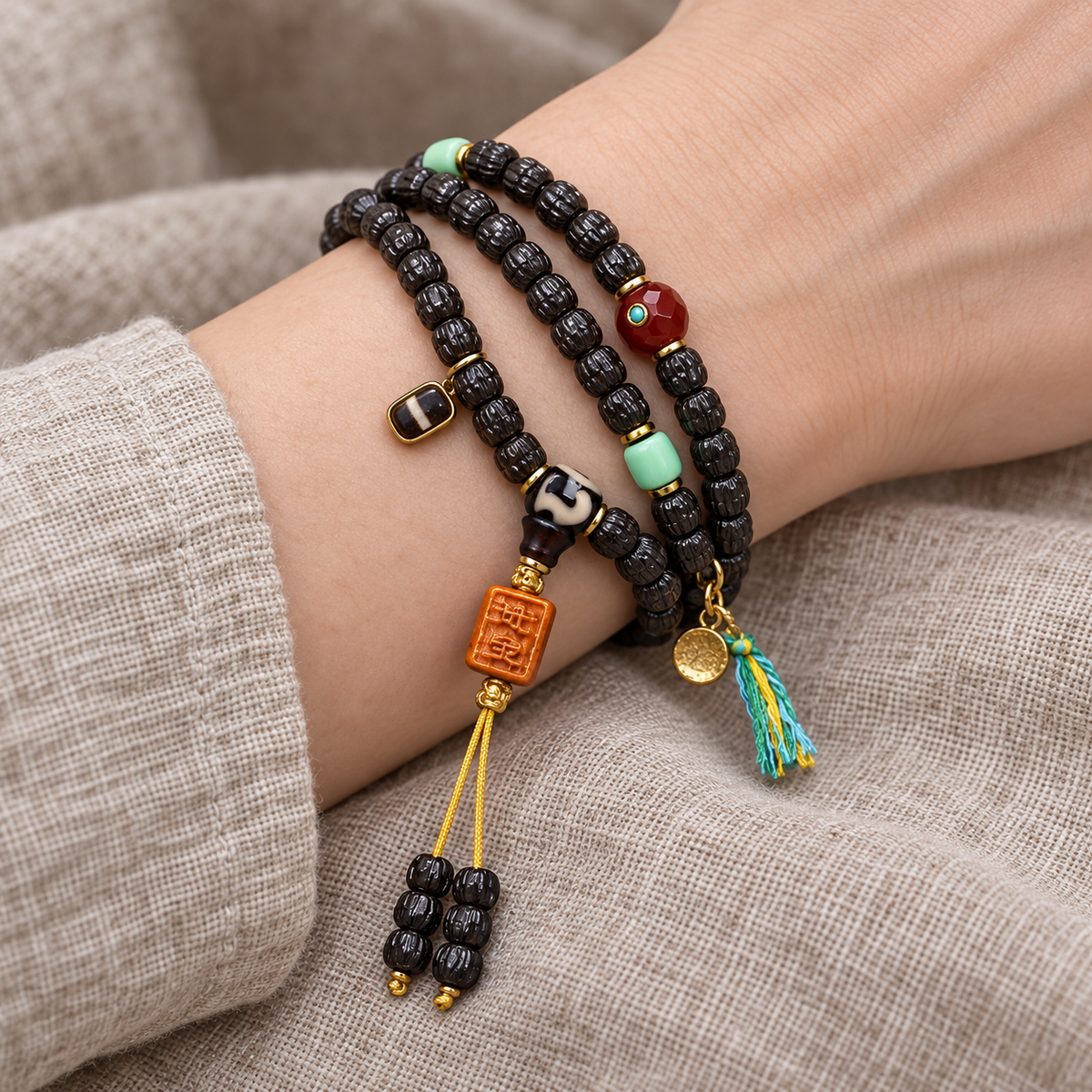EverestArtstudios Coconut Prayer Beads with Carved Seed and Agate Accents — wrist resting