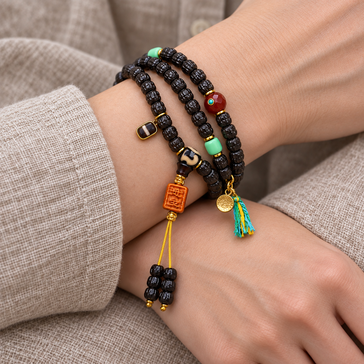 EverestArtstudios Coconut Prayer Beads with Carved Seed and Agate Accents — wrist crossed