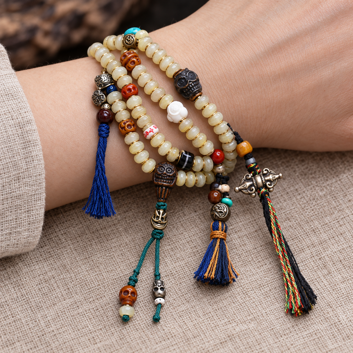 EverestArtstudios Bamboo-Pattern 108-Bead Mala with Carved Charms and Tassels — wrist resting