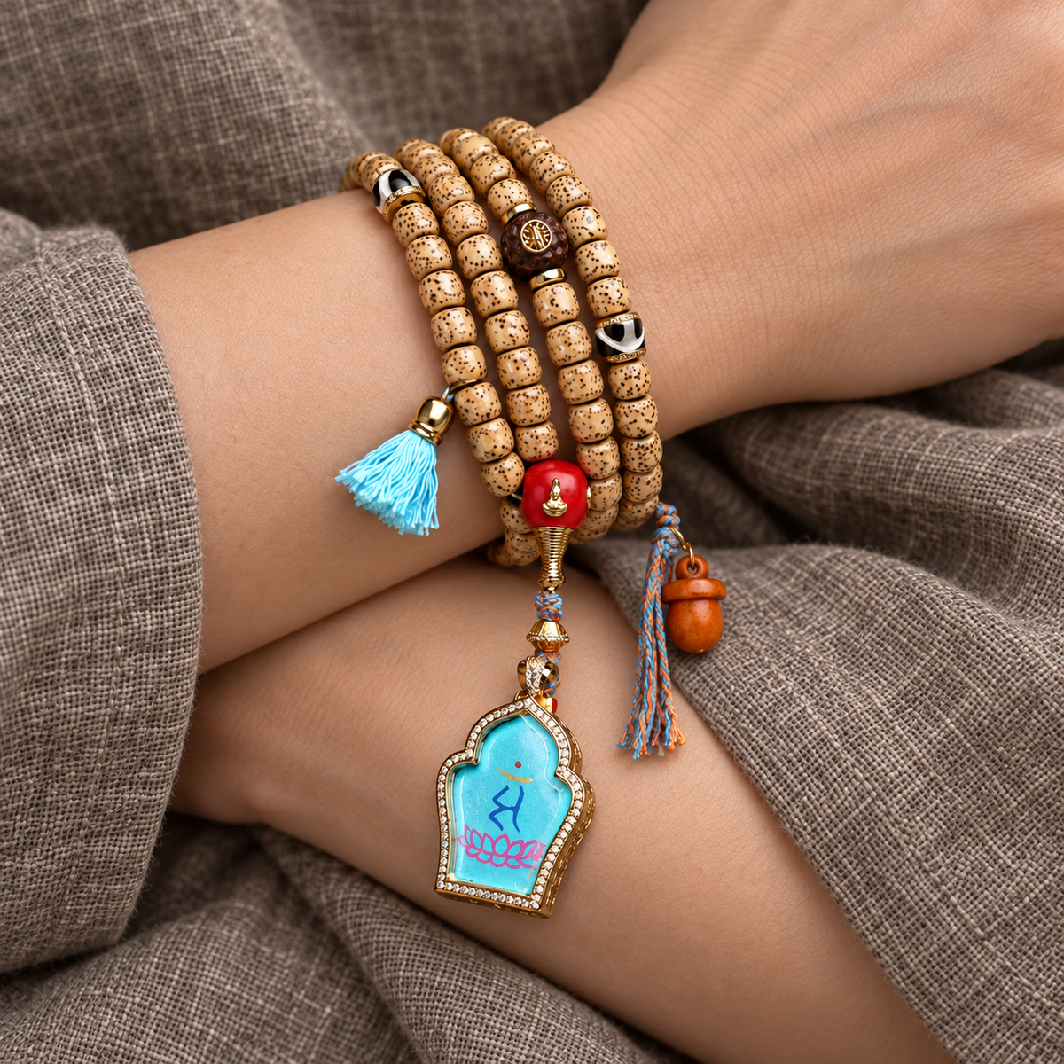EverestArtstudios Xingyue Bodhi 108-Bead Mala with Manjushri-Inspired Thangka Pendant — wrist crossed