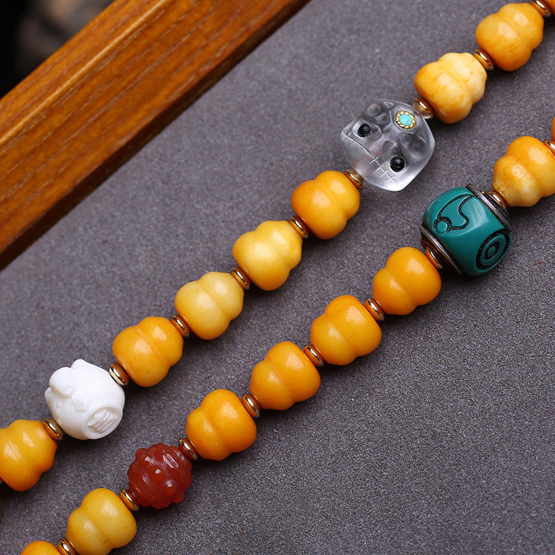 EverestArtstudios Carved Bone Mala with Gourd and Dzi-Style Agate Accents — bead detail