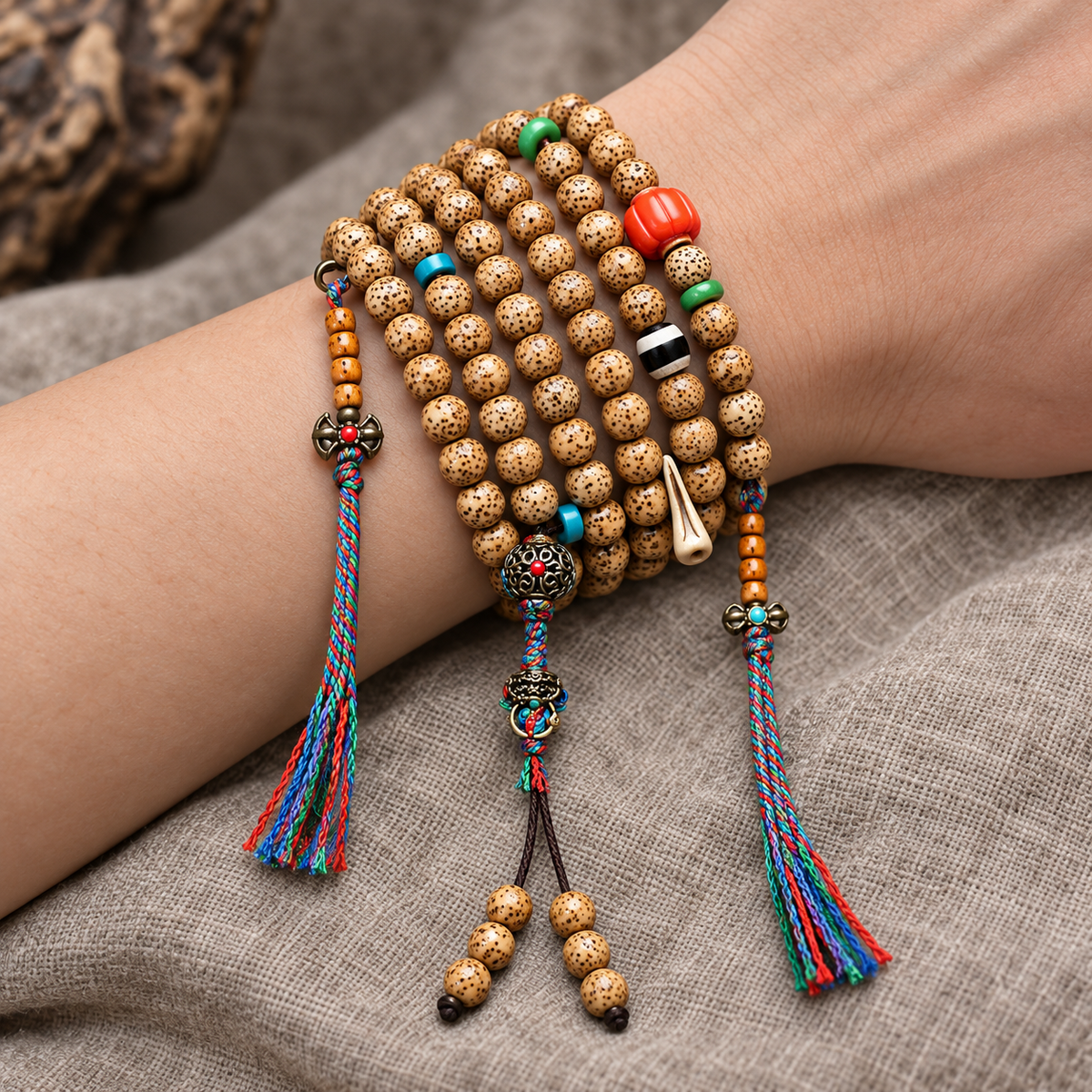 EverestArtstudios Textured Xingyue Bodhi 108-Bead Mala with Coral and Yak Bone Accents — wrist resting