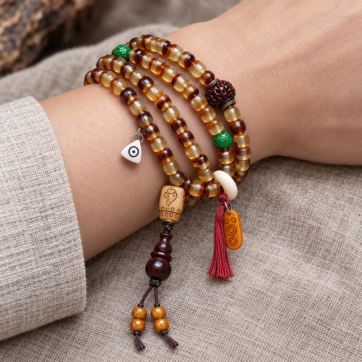 EverestArtstudios Golden Armor Barrel-Bead Mala with Vajra Bodhi and Horn Accents — wrist resting