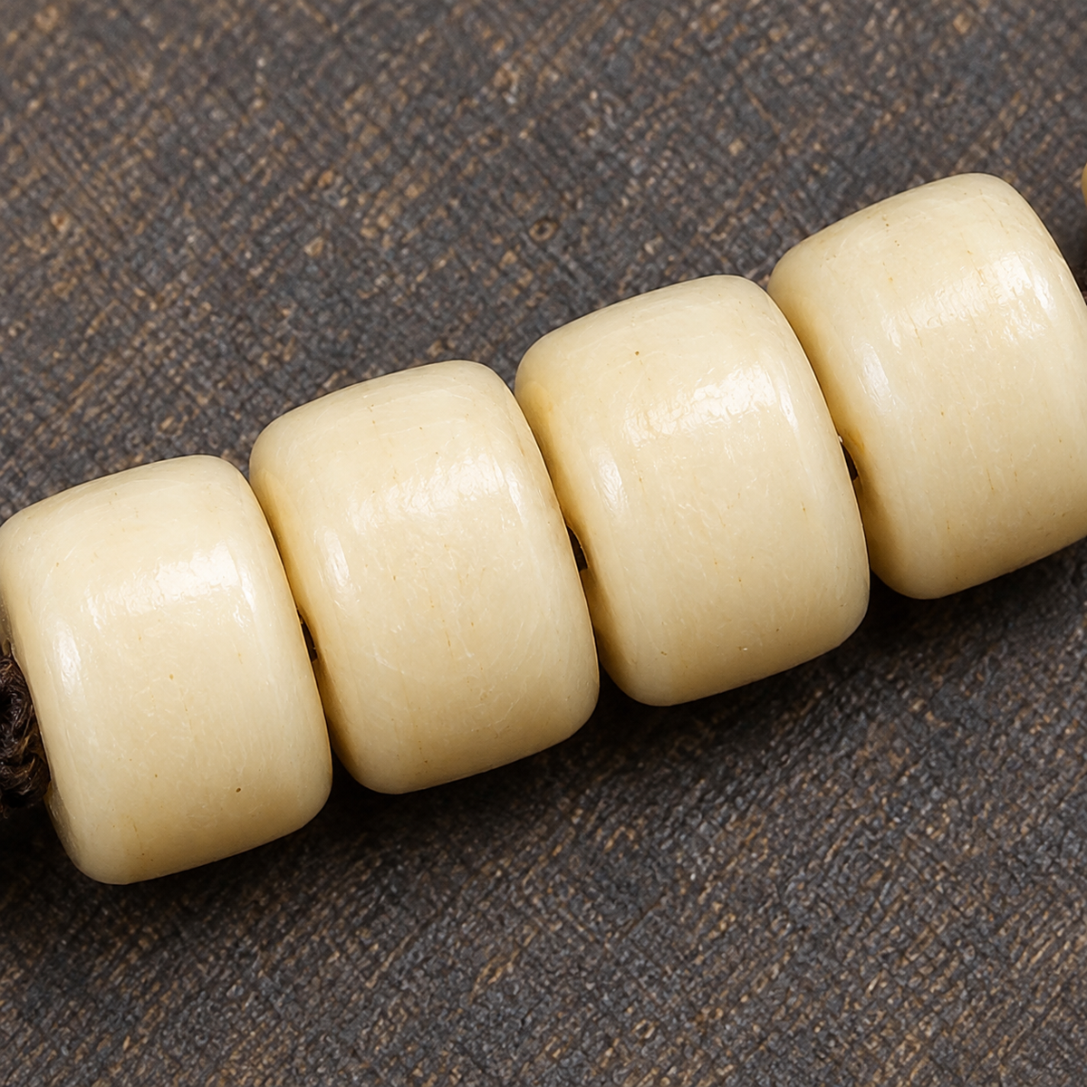 EverestArtstudios Golden-Tone Camel Bone 108-Bead Mala with Carved Accents — surface detail