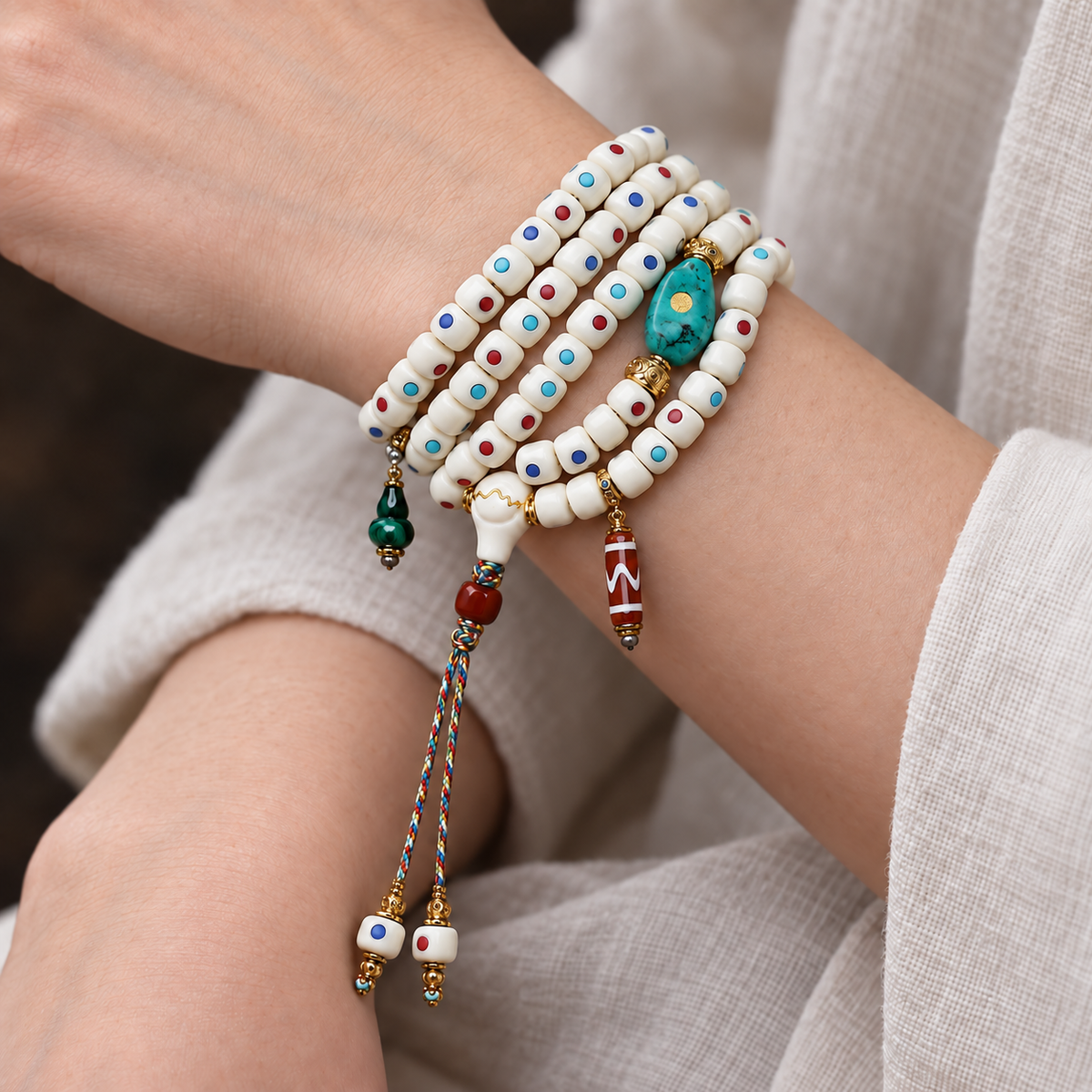 EverestArtstudios Inlaid Deer Bone 108-Bead Mala with Agate and Coconut Accents — wrist crossed