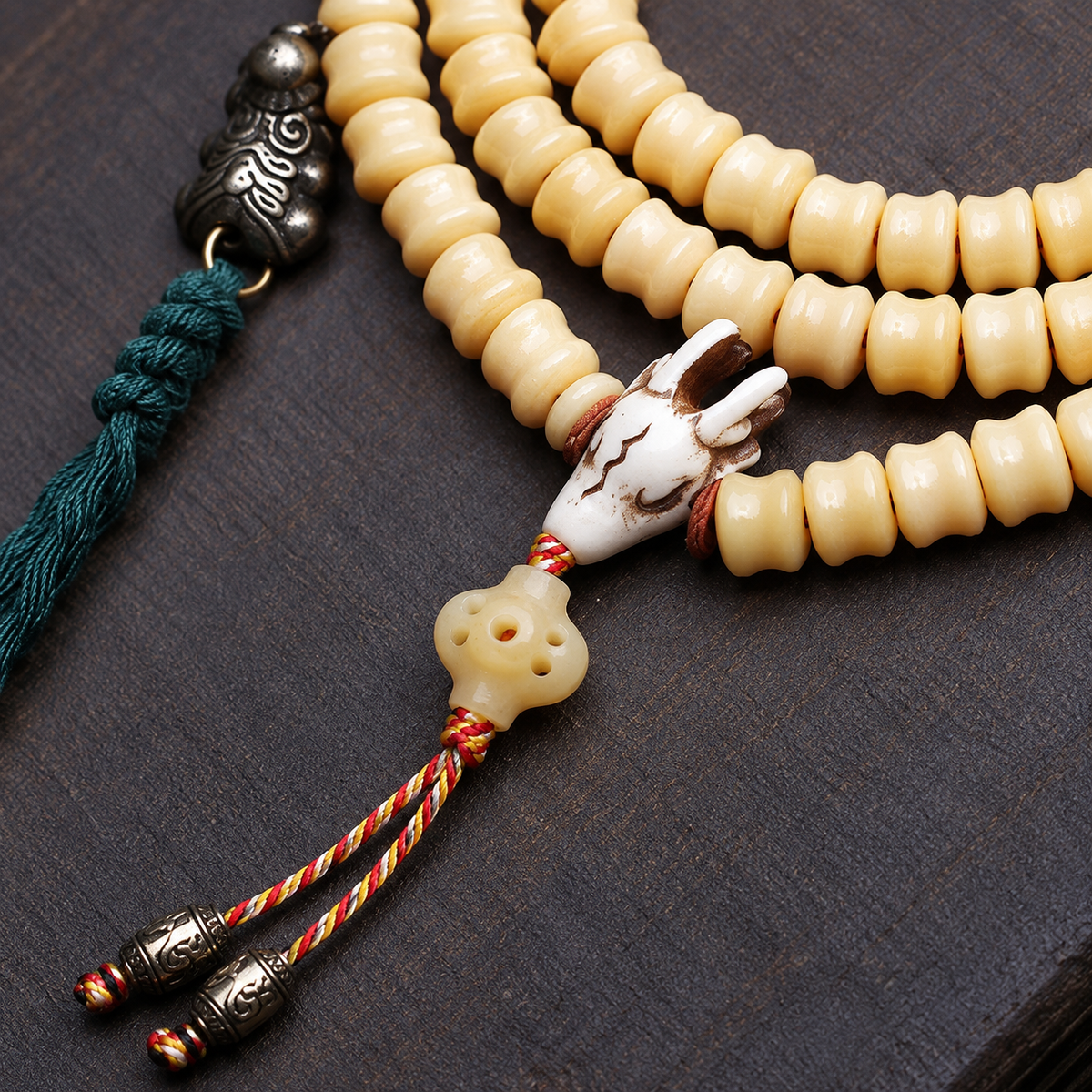 EverestArtstudios Carved Bone 108-Bead Mala with Decorative Metal Charms — connection detail