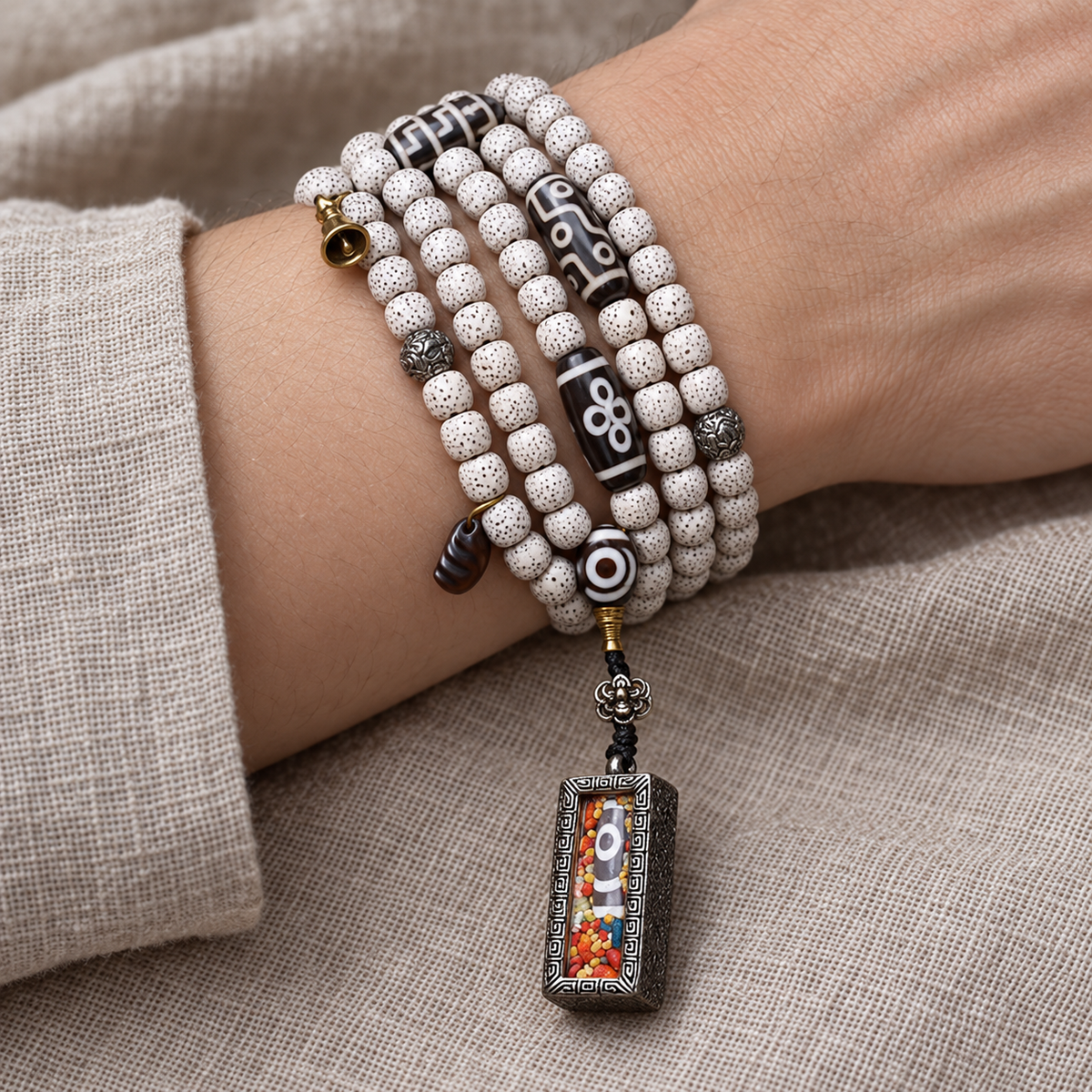 EverestArtstudios Xingyue Bodhi 108-Bead Mala with Two-Eye Dzi-Style Agate and Ghau Pendant — wrist resting