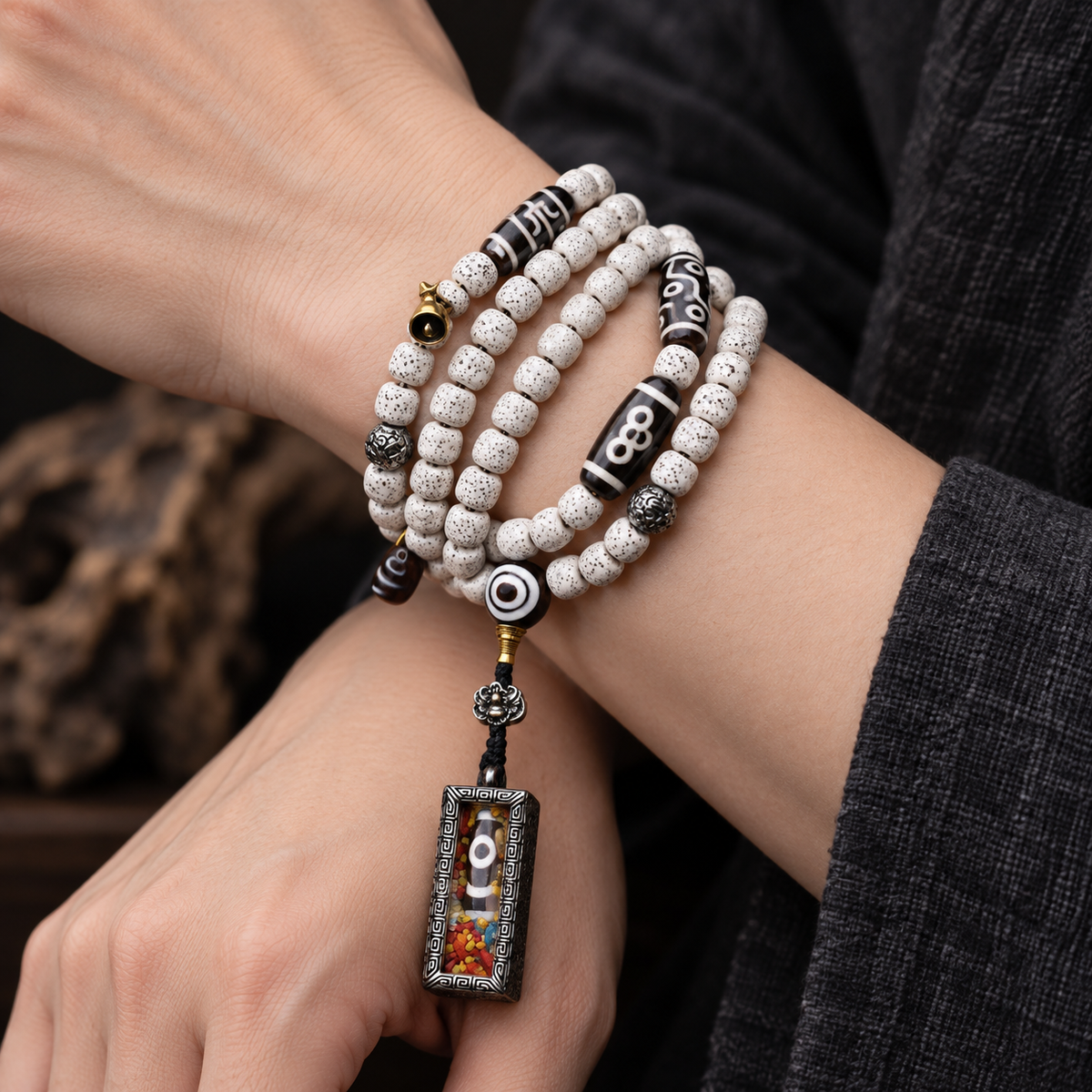 EverestArtstudios Xingyue Bodhi 108-Bead Mala with Two-Eye Dzi-Style Agate and Ghau Pendant — wrist crossed