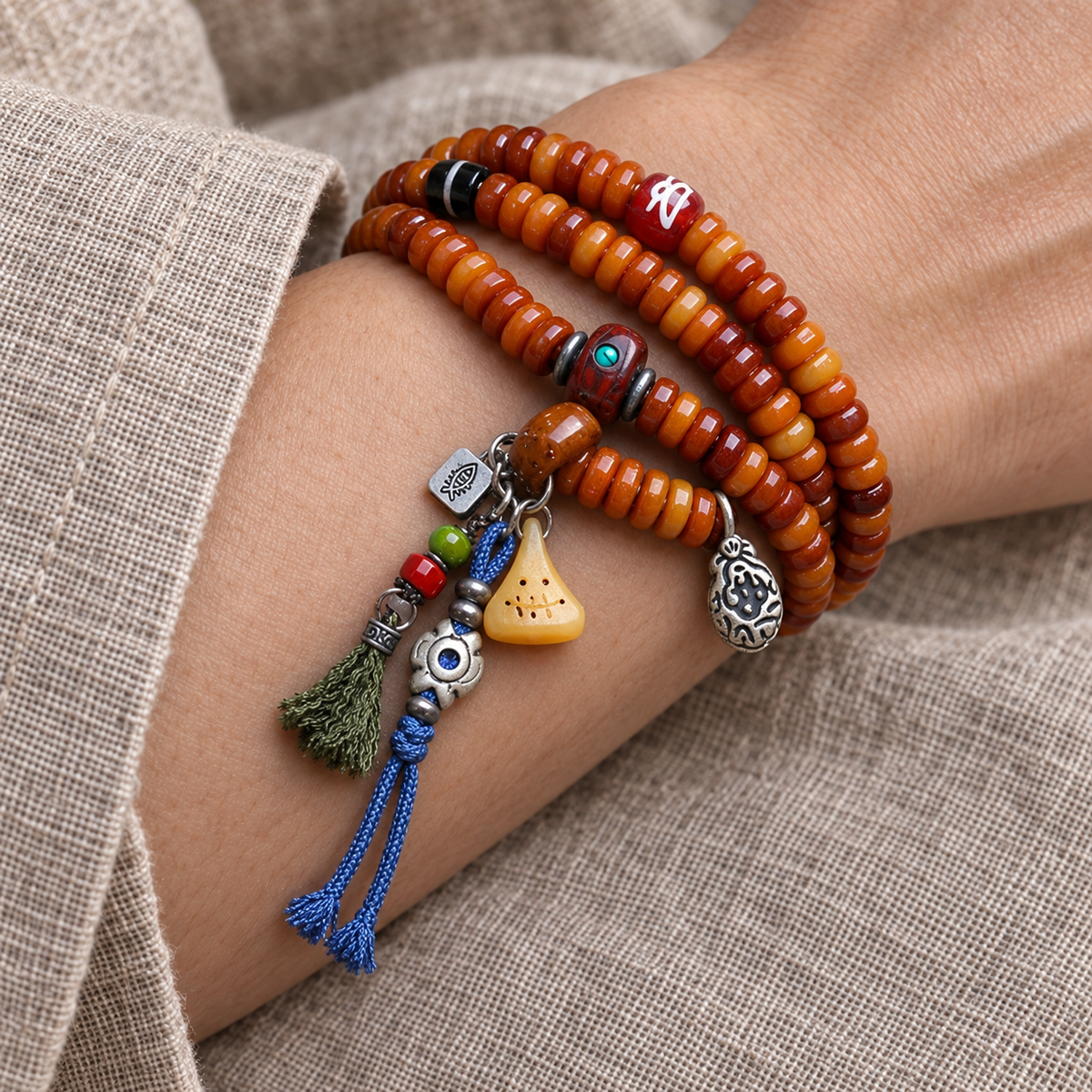 Yak bone mala with Phoenix Eye Bodhi accents — wrist resting