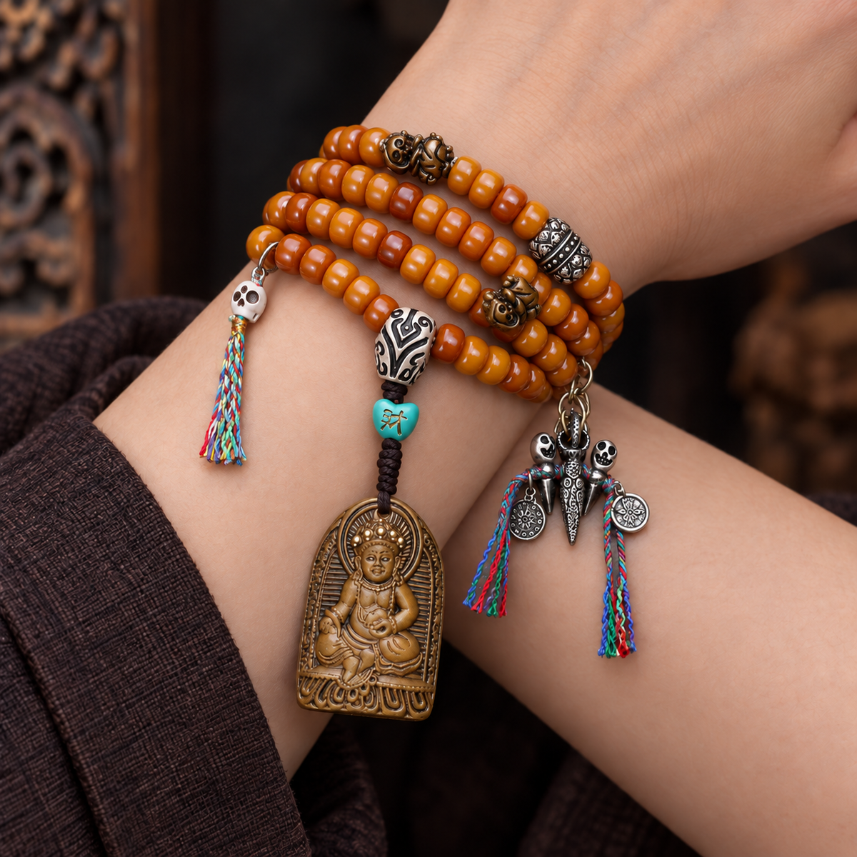 EverestArtstudios Yak Bone 108-Bead Mala with Wealth Deity Pendant and Camel Bone Accents — wrist crossed