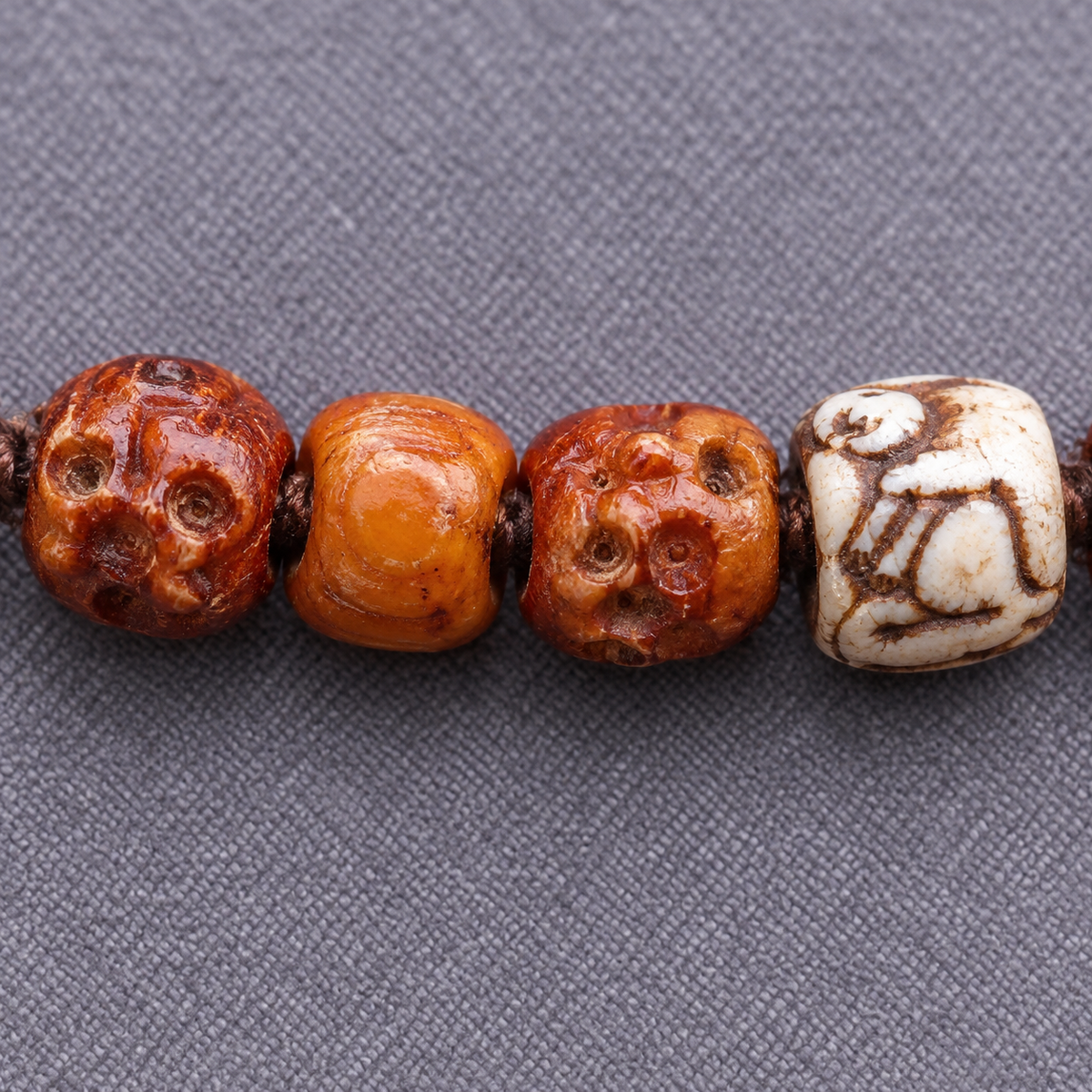 EverestArtstudios Carved Yak Bone 108-Bead Mala with Bagua and Mani Motif Charms — surface detail