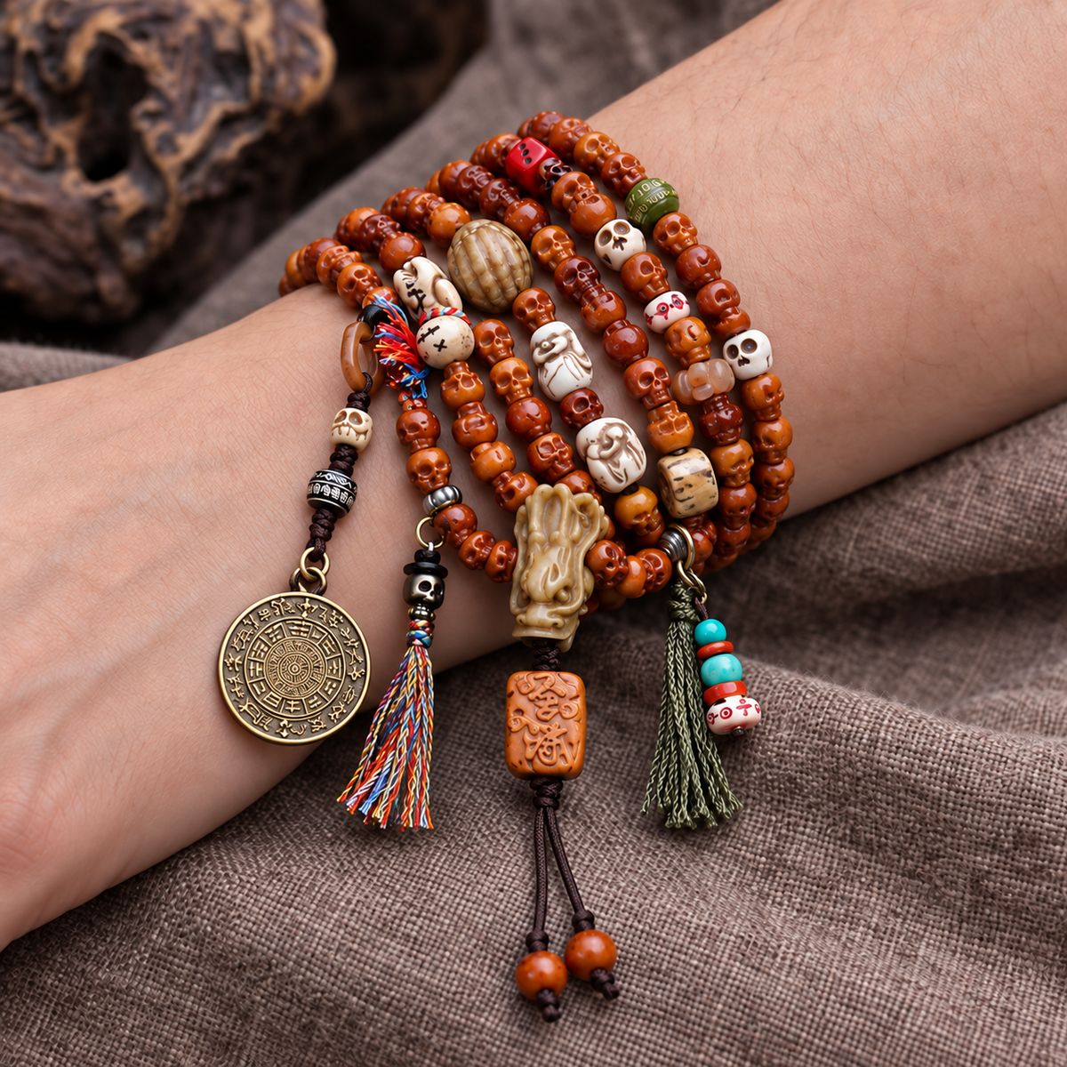 EverestArtstudios Carved Yak Bone 108-Bead Mala with Bagua and Mani Motif Charms — wrist resting