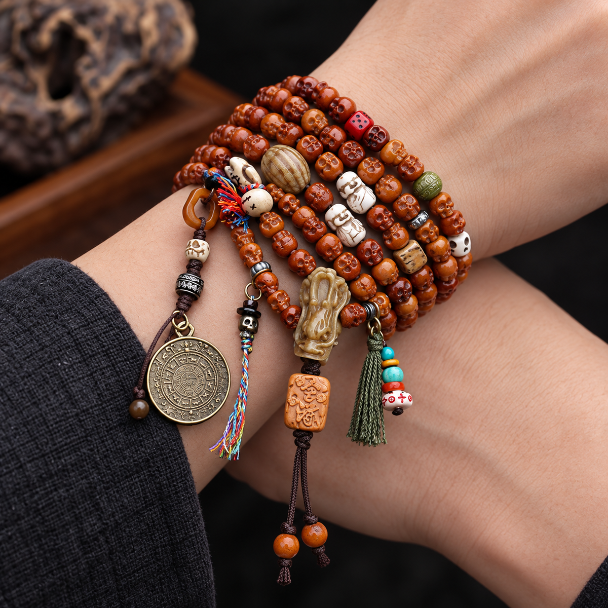 EverestArtstudios Carved Yak Bone 108-Bead Mala with Bagua and Mani Motif Charms — wrist crossed