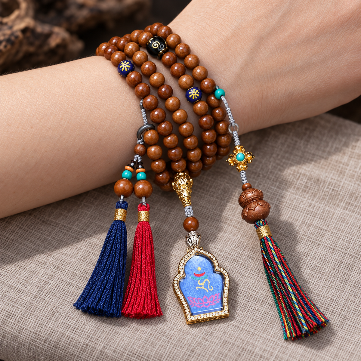EverestArtstudios Medicine Buddha Symbol 108-Bead Mala with Brown Beads and Colorful Tassels — wrist resting