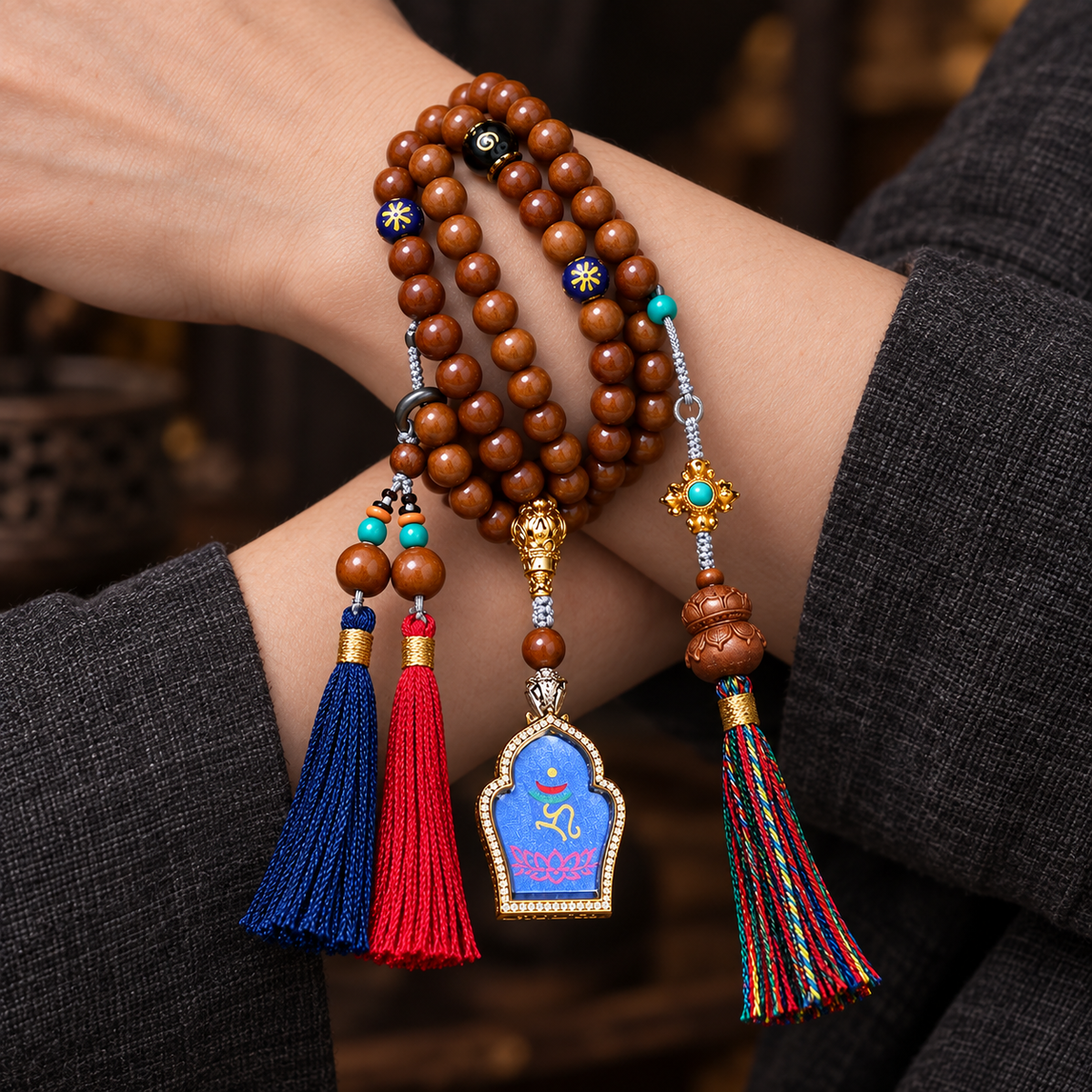 EverestArtstudios Medicine Buddha Symbol 108-Bead Mala with Brown Beads and Colorful Tassels — wrist crossed