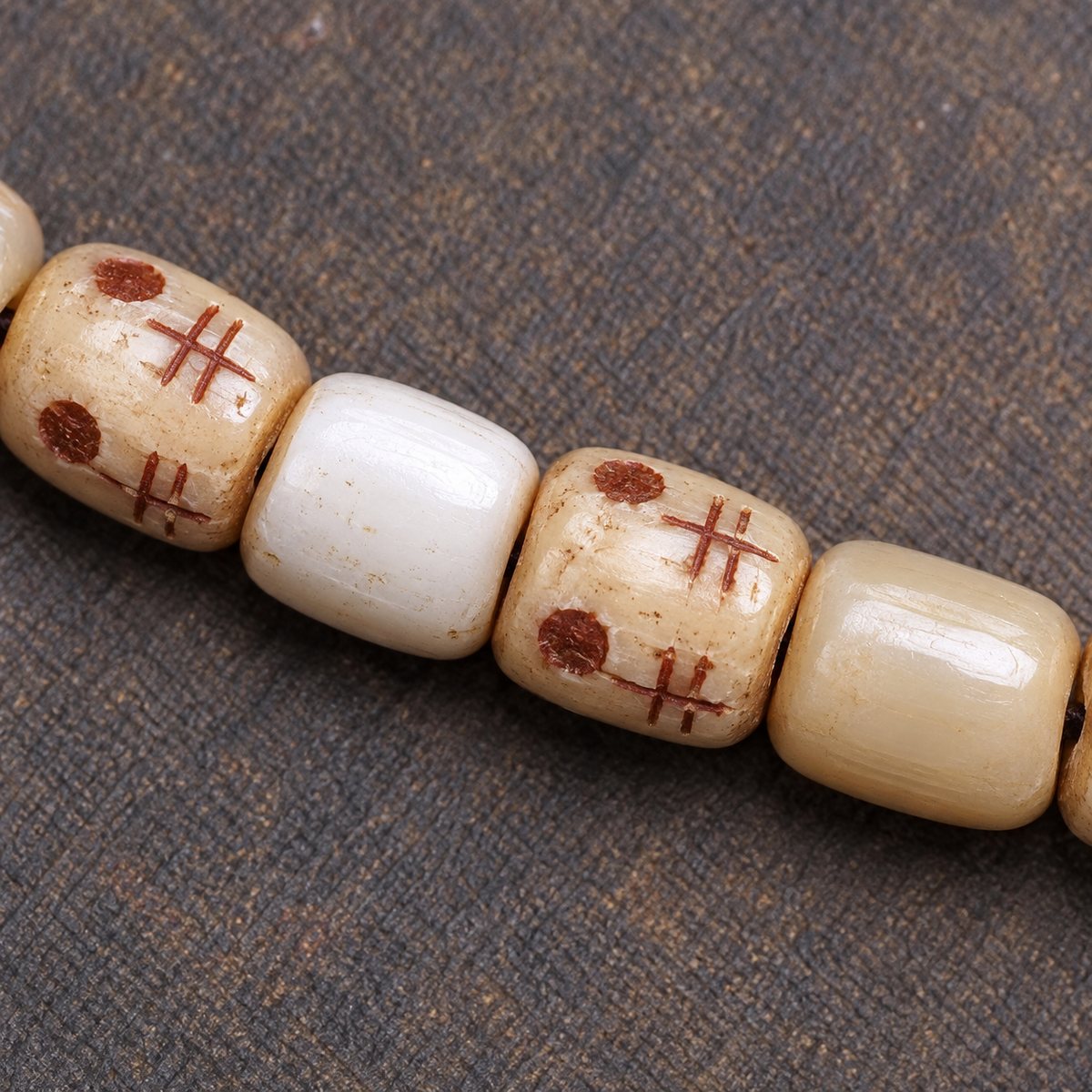 EverestArtstudios Carved Fish Bone 108-Bead Mala with Colorful Accents and Curved Pendant — surface detail