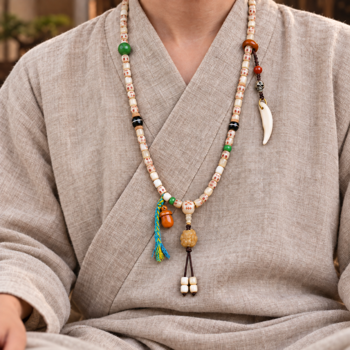 EverestArtstudios Carved Fish Bone 108-Bead Mala with Colorful Accents and Curved Pendant — linen seated