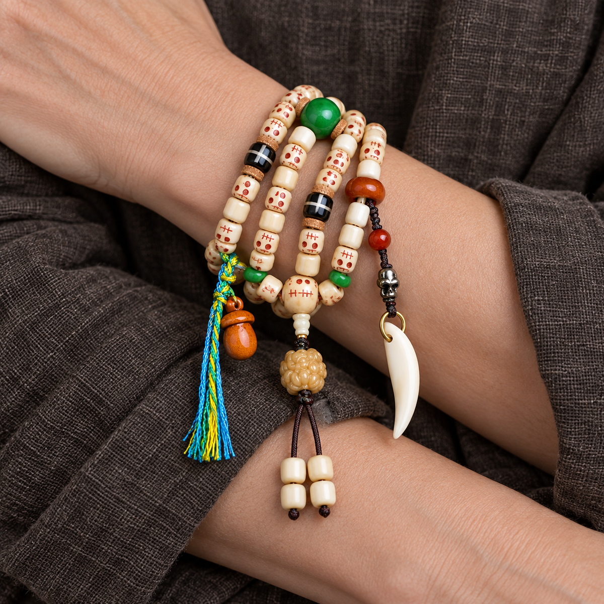 EverestArtstudios Carved Fish Bone 108-Bead Mala with Colorful Accents and Curved Pendant — wrist crossed